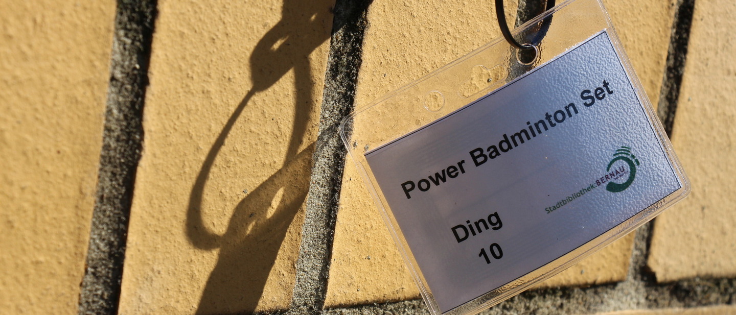 Ein Schild an einem Badmintion-Set womit gekennzeichnet ist, um welches ausleihbare Ding es sich handelt. 
